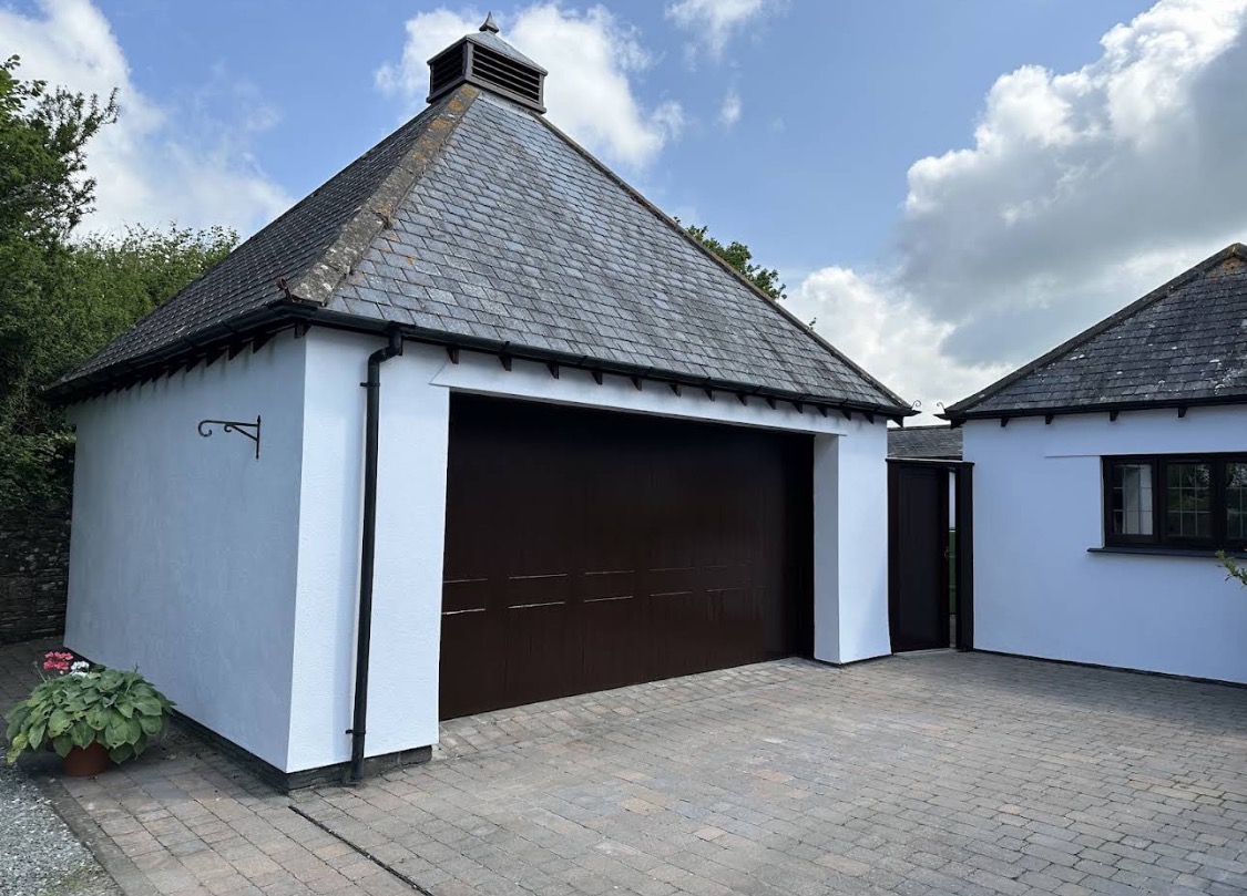 White garage exterior with wooden door