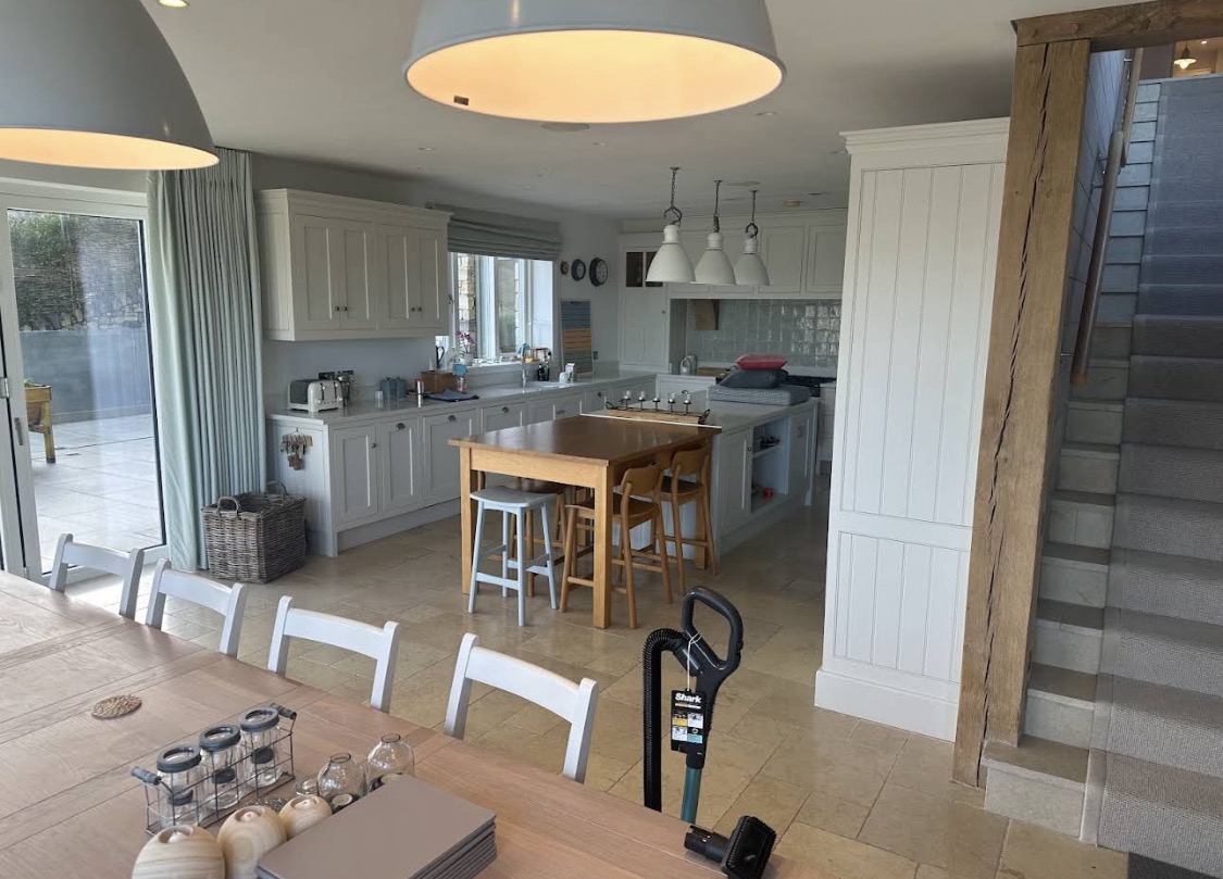 White kitchen-diner — vacuum and equipment visible
