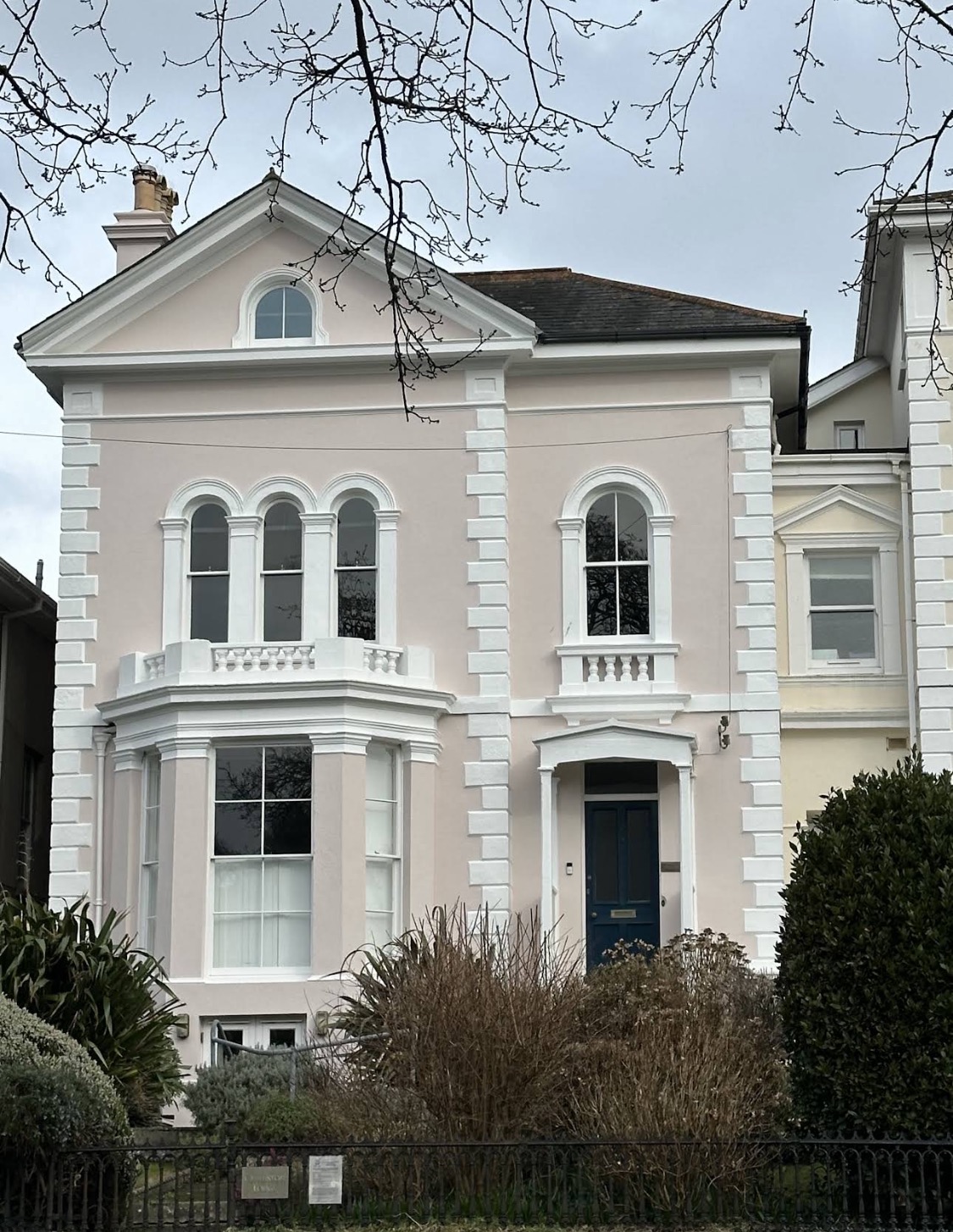 Pink Victorian villa with white window surrounds