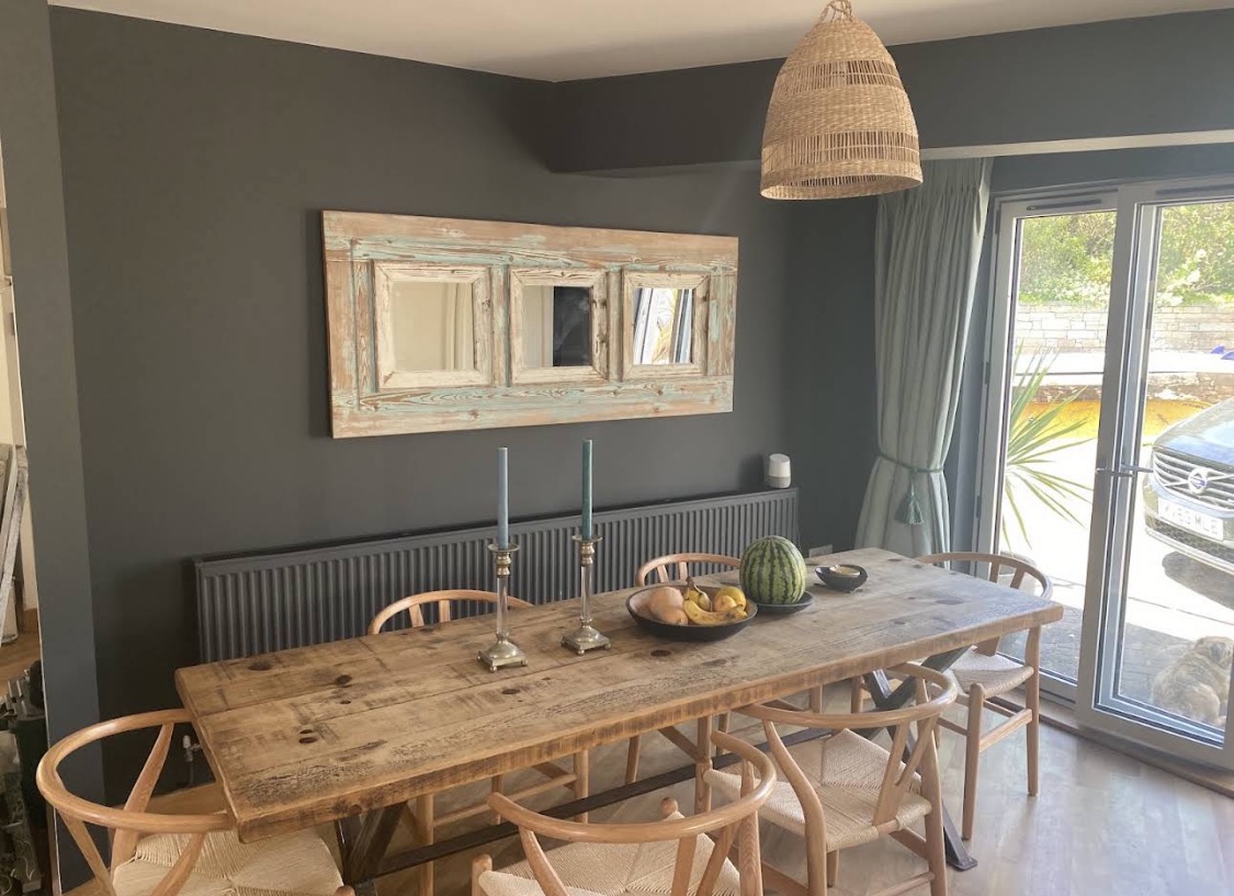 Dark-grey dining room with rustic wooden table