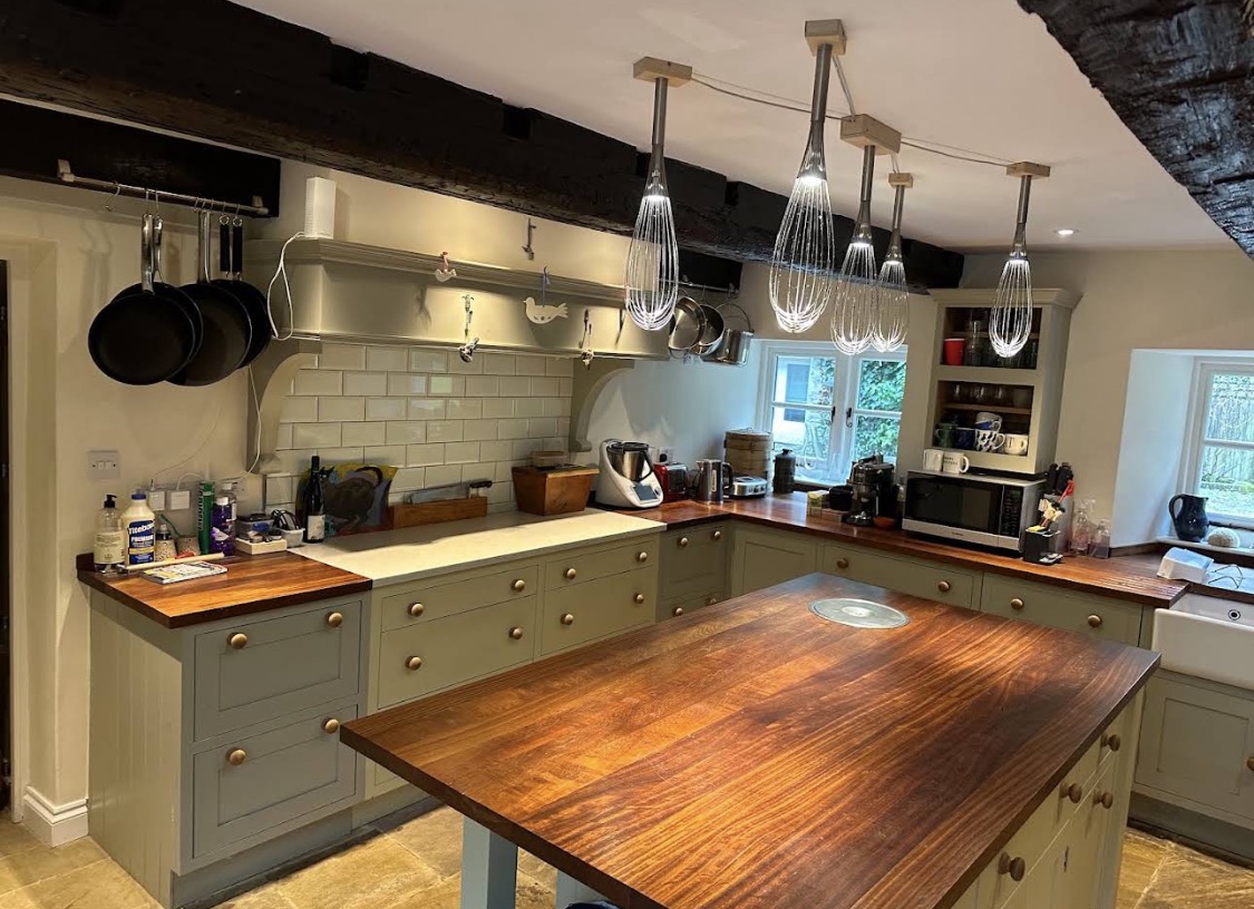 Traditional painted kitchen with wood worktops and exposed beams